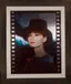 Film strip style portrait of woman in hat with vintage movie aesthetic and decay effects