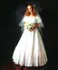 Bride in traditional white wedding gown with veil and bouquet against black backdrop, showcasing classic portrait backdrop setup for formal wedding photography and special events